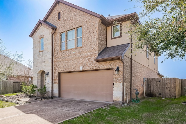 view of front of home featuring concrete driveway, stone siding, an attached garage, fence, and brick siding