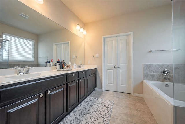 full bathroom with a garden tub, double vanity, a sink, tile patterned flooring, and baseboards