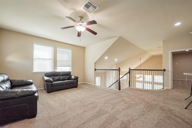 living area with carpet, visible vents, ceiling fan, and baseboards