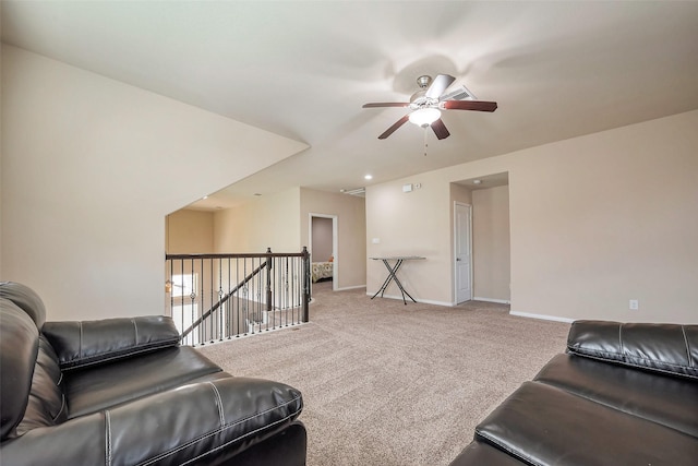 carpeted living area featuring ceiling fan and baseboards