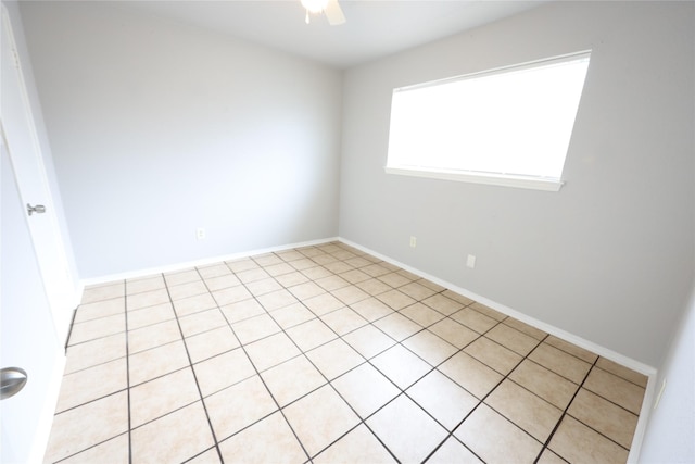 empty room with baseboards and a ceiling fan