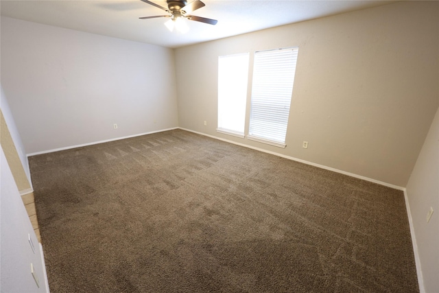 empty room featuring carpet, a ceiling fan, and baseboards