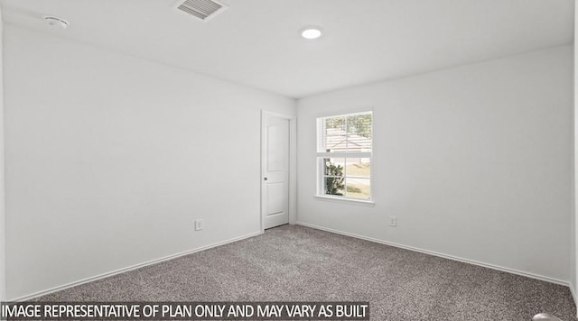 carpeted spare room with baseboards and visible vents