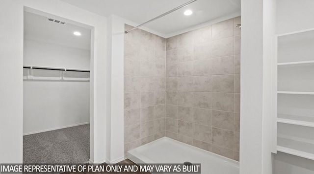 full bath with a spacious closet, a stall shower, and recessed lighting