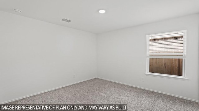 spare room featuring carpet, visible vents, and baseboards