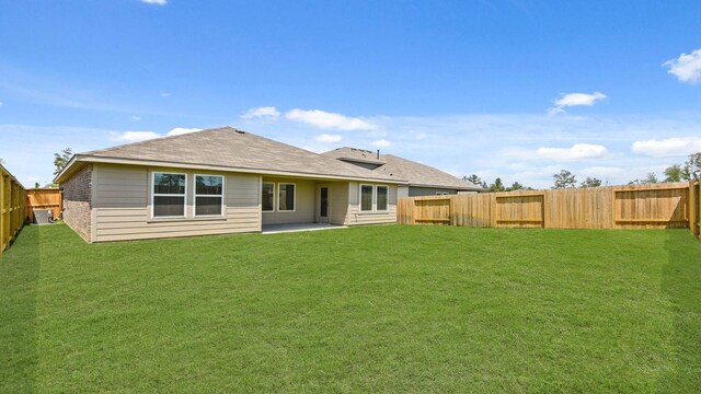 14615 Lost Cave Way, New Caney, TX 77357 - back of property with a lawn, a fenced backyard, and a patio area