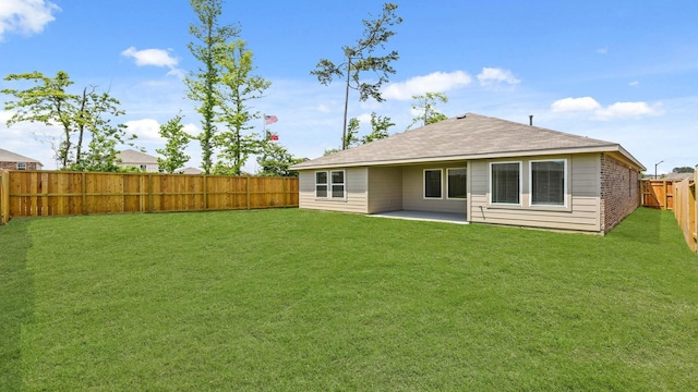 14615 Lost Cave Way, New Caney, TX 77357 - rear view of property with a yard, roof with shingles, a patio, and a fenced backyard