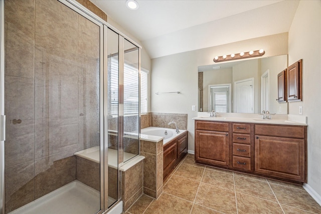 full bathroom featuring lofted ceiling, a garden tub, a sink, a shower stall, and double vanity