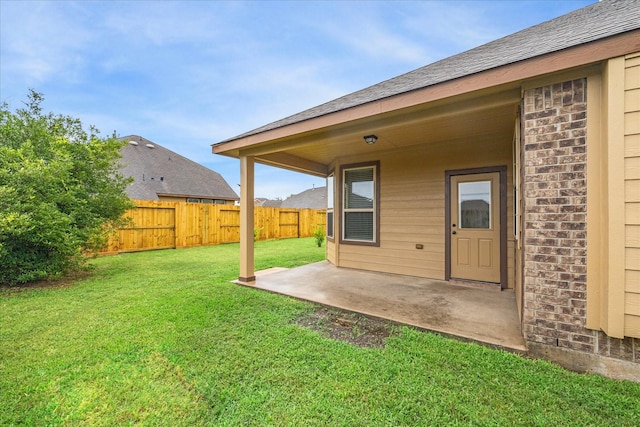 view of yard with fence and a patio