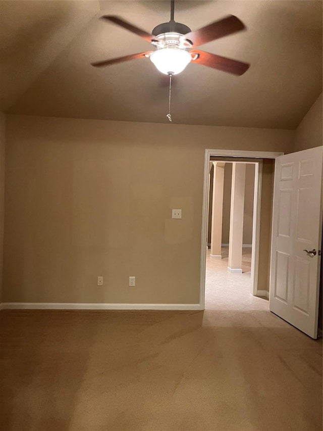 unfurnished room featuring baseboards, ceiling fan, and light colored carpet