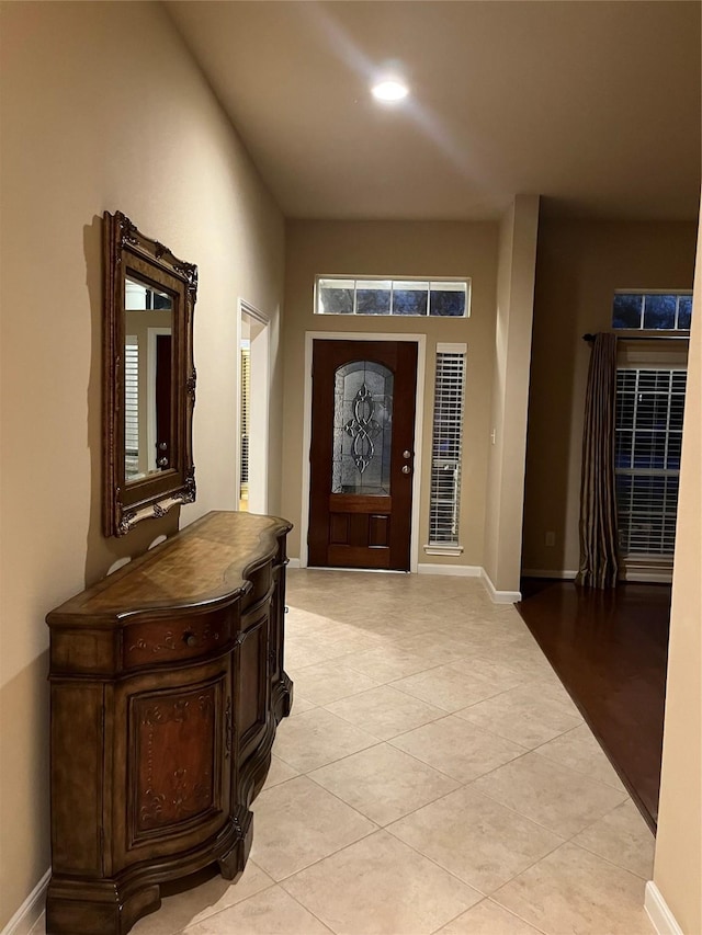 foyer with light tile patterned floors, baseboards, and recessed lighting