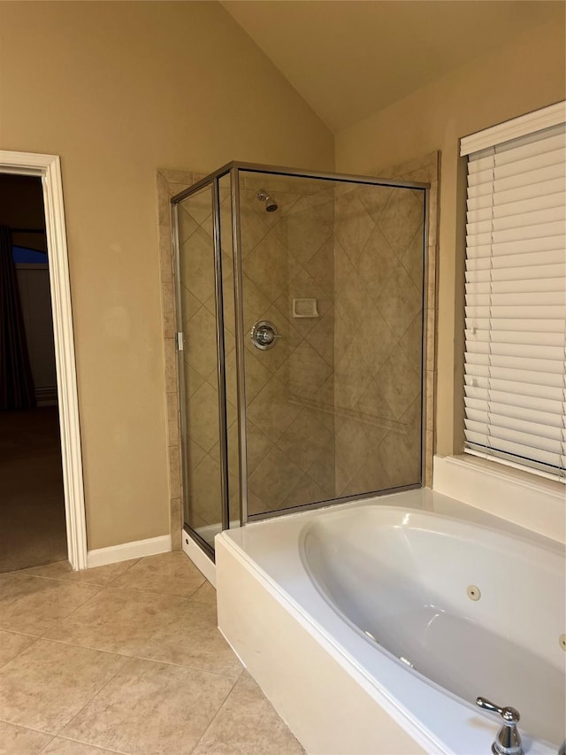 full bathroom featuring baseboards, vaulted ceiling, a jetted tub, a shower stall, and tile patterned floors