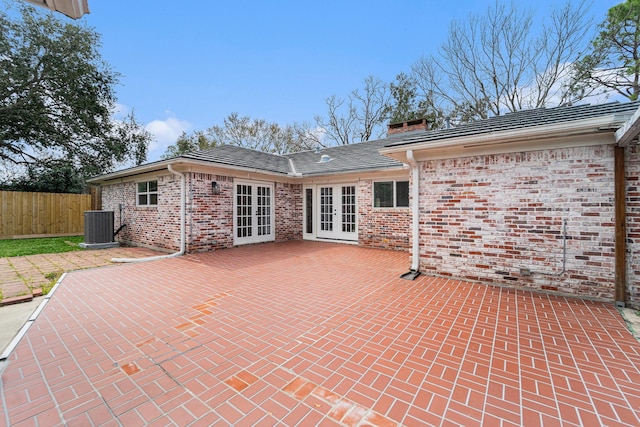 back of property featuring a patio area, french doors, brick siding, and fence