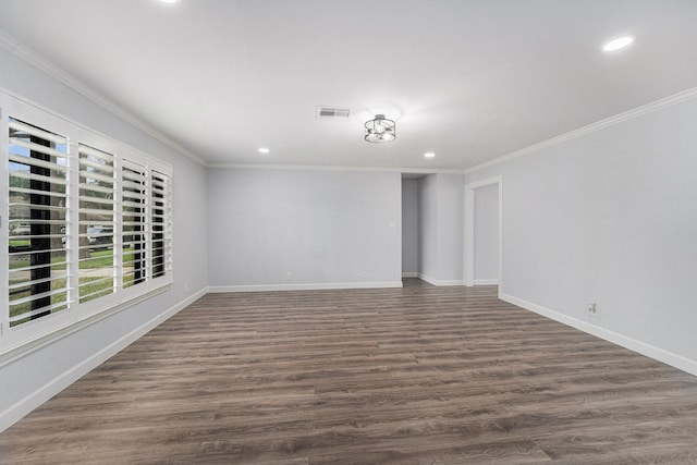 unfurnished room featuring baseboards, visible vents, and crown molding