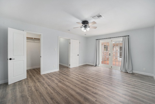 unfurnished bedroom with french doors, visible vents, baseboards, and wood finished floors