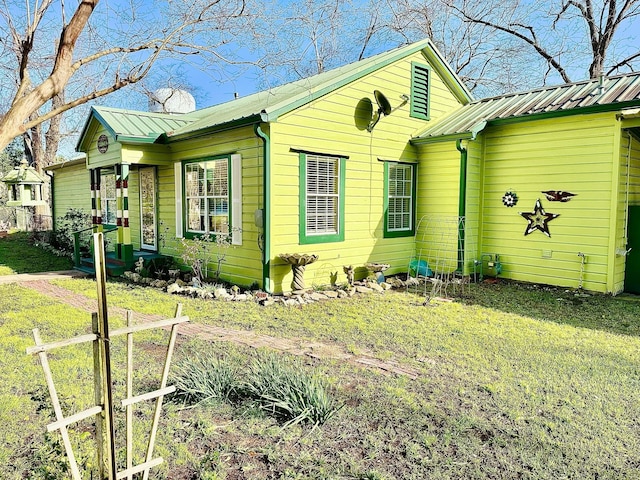 view of side of home with fence and metal roof