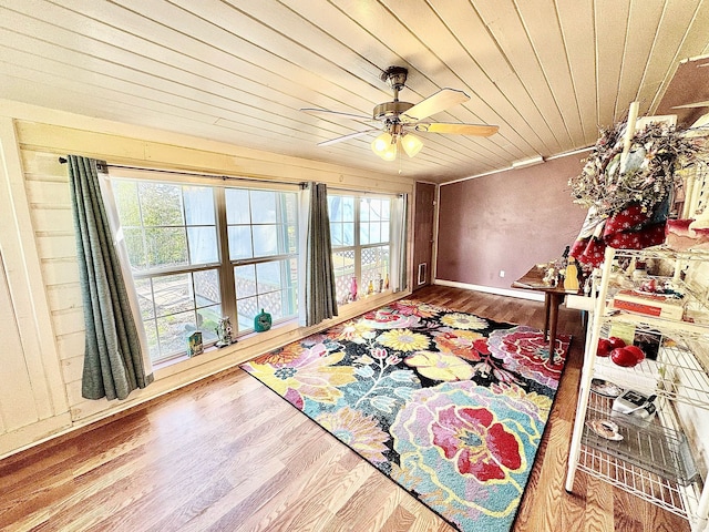 interior space featuring a ceiling fan, wood ceiling, and wood finished floors