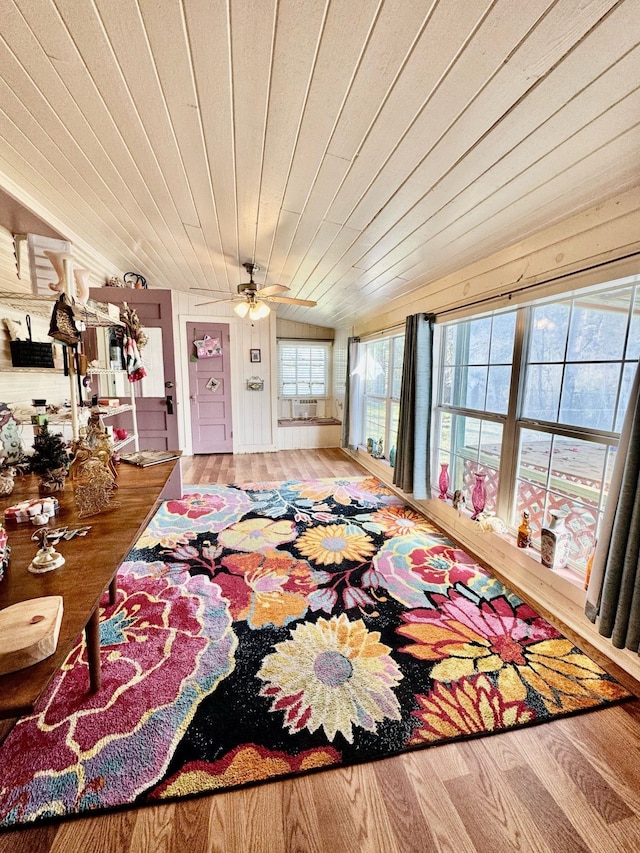 living room with wooden ceiling, wood finished floors, and a ceiling fan