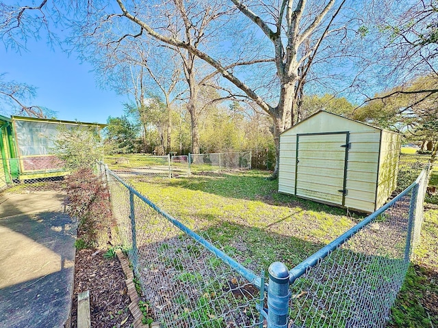 view of yard with an outbuilding, fence, and a storage unit