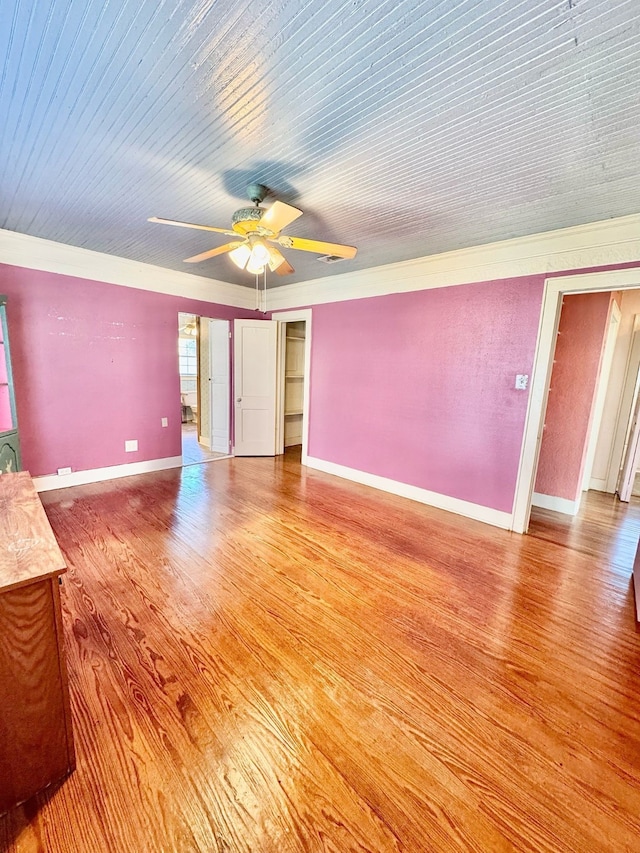 unfurnished living room with light wood-style floors, ceiling fan, and baseboards