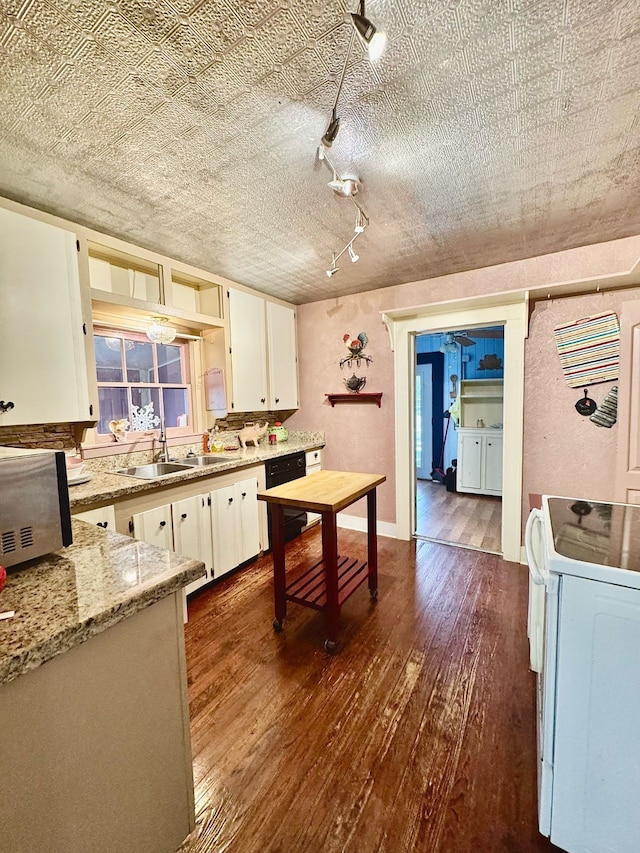 kitchen with white electric stove, independent washer and dryer, dark wood finished floors, and dishwasher