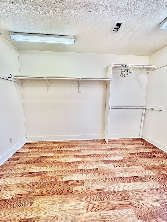 walk in closet with visible vents and light wood-style flooring