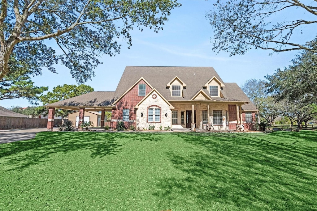 32680 Teal St, Brookshire, TX 77423 - view of front facade featuring brick siding, fence, and a front yard
