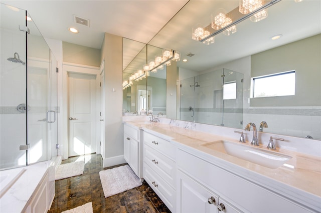 full bathroom featuring visible vents, a sink, a shower stall, and double vanity