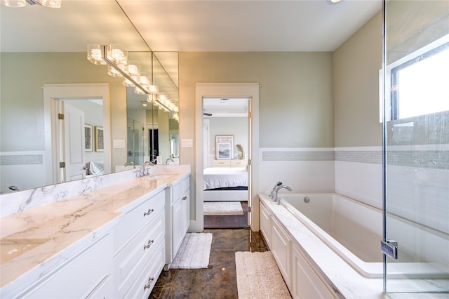 bathroom featuring a garden tub, vanity, and ensuite bathroom