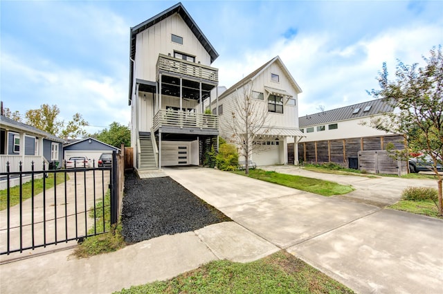 view of front facade with a balcony, fence, and board and batten siding