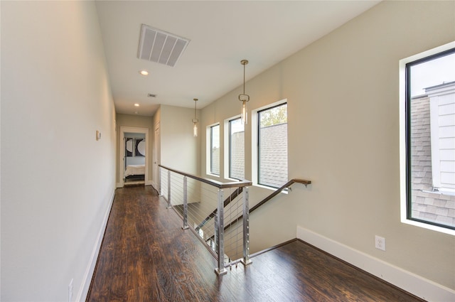 hallway featuring recessed lighting, visible vents, an upstairs landing, wood finished floors, and baseboards