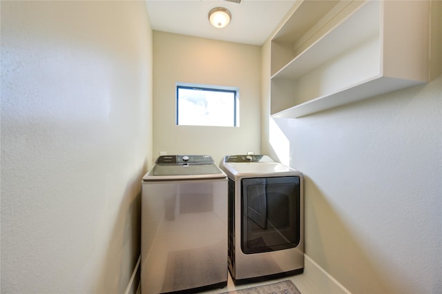 washroom with laundry area and separate washer and dryer