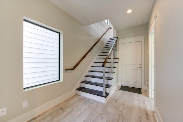 stairs with recessed lighting, baseboards, and wood finished floors