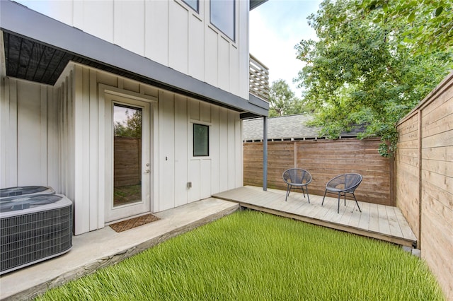 exterior space with central air condition unit and fence