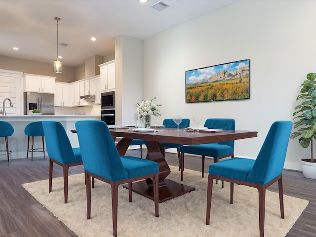 dining room featuring recessed lighting, wood finished floors, visible vents, and baseboards