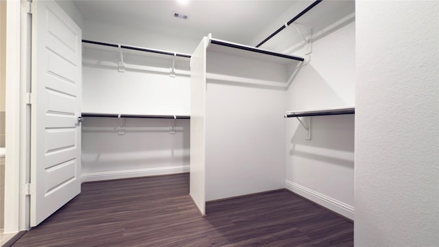 walk in closet with visible vents and wood finished floors