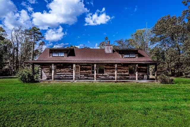 view of front facade featuring covered porch, roof with shingles, a front lawn, and a chimney