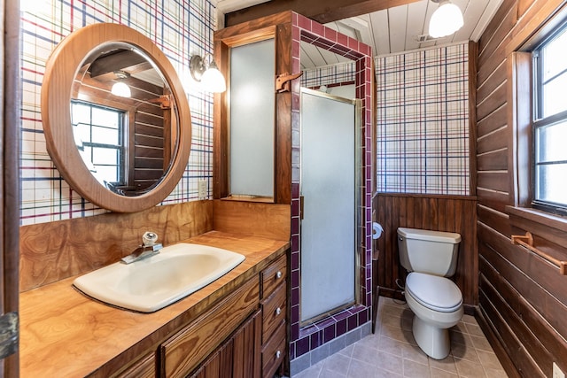 bathroom featuring toilet, a shower stall, wooden walls, and tile patterned flooring