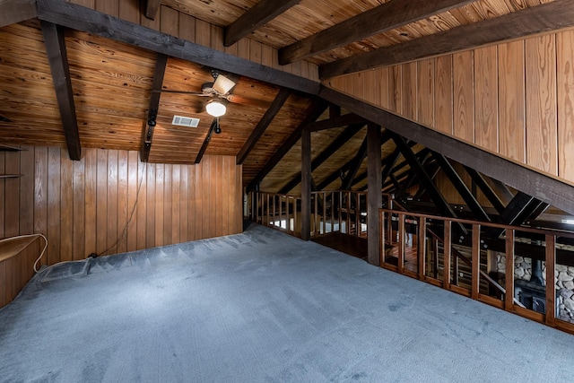 interior space featuring wood walls, beamed ceiling, carpet flooring, and wood ceiling