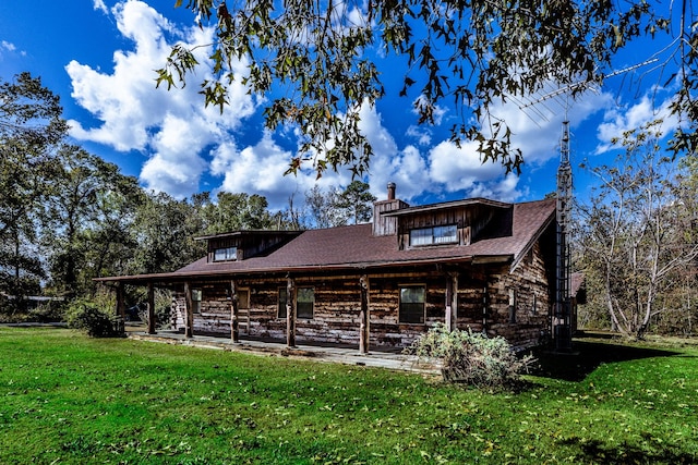 exterior space featuring a front lawn and a chimney