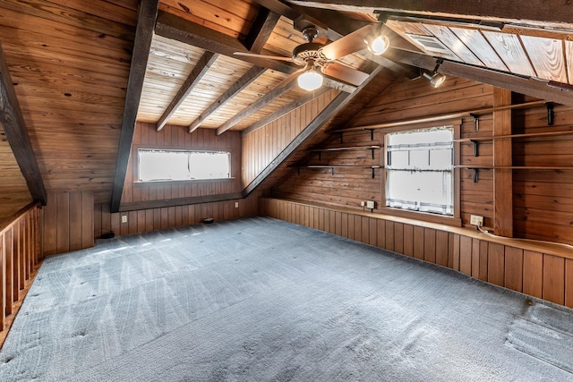 bonus room with wooden ceiling, ceiling fan, vaulted ceiling with beams, carpet floors, and wood walls