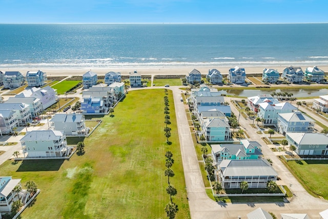 bird's eye view with a residential view, a water view, and a beach view