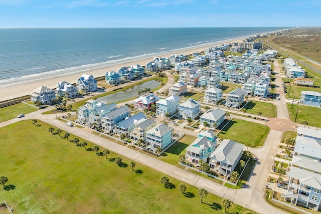 drone / aerial view with a water view and a beach view