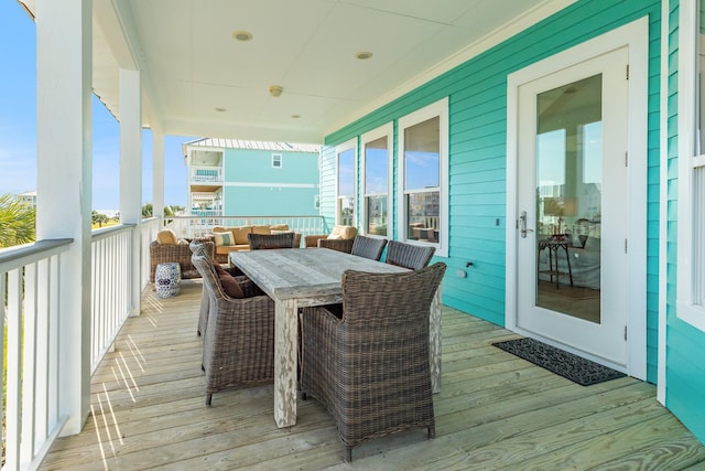 wooden terrace with an outdoor living space