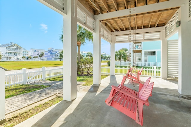 view of patio featuring a residential view and fence