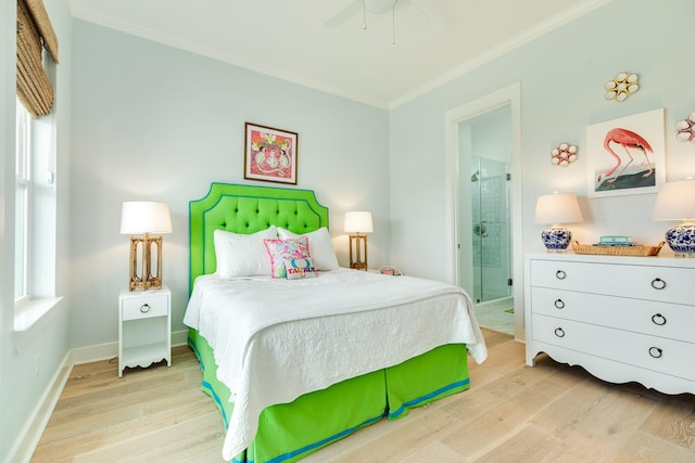 bedroom with crown molding, light wood-style flooring, baseboards, and ensuite bathroom