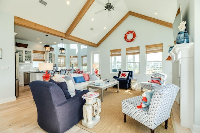 living room with high vaulted ceiling, light wood-type flooring, beam ceiling, and visible vents