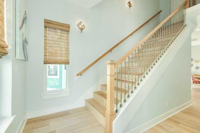 stairs with baseboards and wood finished floors