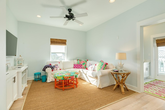 living area featuring a ceiling fan, a wealth of natural light, light wood-style flooring, and recessed lighting