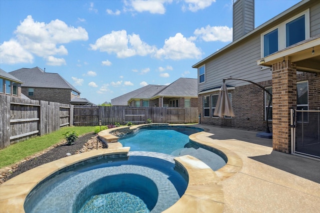 view of swimming pool with a fenced backyard, a pool with connected hot tub, and a patio